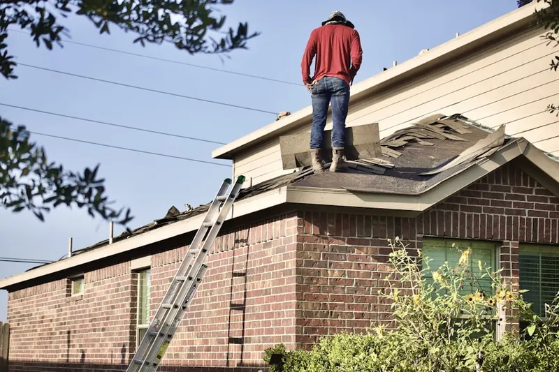 Professional roofer working on a residential roof in The Woodlands at Fiore